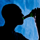 A man is seen drinking from a beer bottle