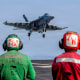 An F/A-18E Super Hornet, attached to Strike Fighter Squadron (VFA) 151, preparing to make an arrested landing on the flight deck of Nimitz-class aircraft carrier USS Abraham Lincoln