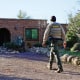 A member of the Pima County sheriff's office walks outside of Nancy Guthrie's home on Feb. 9, 2026 in Tucson, Ariz. 
