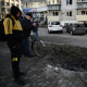 Residents look at a crater as police expert work at a site of a strike in the town of Brovary, near Kyiv, following a Russian missile and drone attack, on March 14.