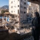 A woman named Narges looks out from her destroyed apartment in the remains of a residential and commercial building on March 21, in the Shahrak-e Gharb neighbourhood of Tehran, Iran. 