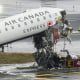 A destroyed plane is seen on the tarmac outside