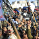 Houthis brandish their weapons as they rally in solidarity with Iran and Lebanon, amid the US-Israeli war with Iran, in the Yemeni capital Sanaa.