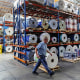 An employee at Emerald Packaging walks by rolls of plastic at the company’s facility in Union City