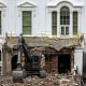 Rubble lies in front of the White House. An excavator is parked on top of it.