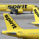 Three Spirit Airlines jets sitting on a tarmac.