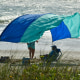 Photo shows a beachgoers sun canopy flapping in the strong winds at Tables Beach