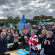 Crowds cheer Reform party leader Nigel Farage as he takes the stage at a rally in Merthyr Tidfil, Wales on Tuesday.