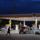 A person walks past a gas station on Wednesday, May 6, 2026, in Portland, Ore.