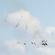A blurred photo of four pilots parachuting from two fighter jets after a mid-air collision.