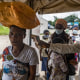 A border health officer at the Busunga crossing between Uganda and the Democratic Republic of Congo checks a traveler's temperature.