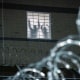 Detainees stand by a window inside the federal immigration center.
