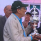 Wes Moore hands the Woodlawn Vase to Al Gold, owner of Napoleon Solo, and reacts to winning the Preakness Stakes.