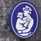 The logo of a nurse holding a child hangs on a wall outside the Boston Children's Hospital, on Aug. 18, 2022.
