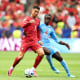 Cristiano Ronaldo of Portugal is challenged by Axel Tuanzebe on the soccer field