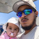 Friedrich Castillo-Ormeno holds a baby using a binky