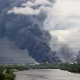 Thick plumes of smoke with flames rise from an oil refinery following a Ukrainian drone attack in Moscow