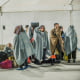 Migrants seen sheltering in the first aid camp