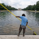 A worker cleans the waters of the Reflecting Pool in Washington on June 22, 2026.