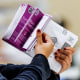 Vote by Mail ballots are inspected by a worker who flips through the envelope