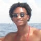 Nolan Xavier Wells outside on a boat smiling for a photo