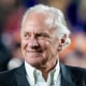 Donald Trump, left, and Henry McMaster walk next to each other on a football field