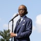 Al Sharpton standing at a microphone outdoors.