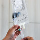 a caregiver checks an infusion IV