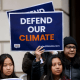 Demonstrators hold signs outside of the Environmental Protection Agency (EPA) headquarters in Washington, DC.