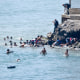 People swim across the border.