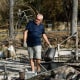 A man searches through the rubble