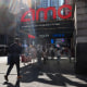 People walking past an AMC Movie Theater in Times Square in New York City.