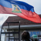 Patricia Grace Louis-Jacques with the Haitian flag.