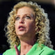 Debbie Wasserman Schultz speaks at a podium in an arena