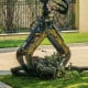 Grapple hook on crane picking up logs -storm debris in upscale neighborhood