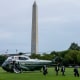 United States Secret Service agents walk away from a helicopter. 