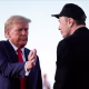 Donald Trump, left, leans in to pat Elon Musk's shoulder outside on stage during a rally