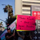 A person holds a sign that says "Trans Rights Are Human Rights"