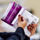 Vote by Mail ballots are inspected by a worker who flips through the envelope