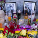 A memorial with two photographs, candles and flowers sits outside Venture-N Bar in Tucson.
