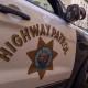 California Highway Patrol officers and vehicle is seen in the street.