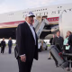 Donald Trump speaking to reporters on a tarmac.