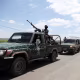 Yemeni security forces escort buses carrying released Houthi-aligned detainees as they arrive in Sana'a on September 12.