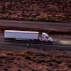 White Semi-truck Crossing Mojave Desert Near California-Nevada Border - High Angle, Aerial