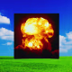 Photo illustration of green grass and bright blue sky with an inset of a mushroom cloud, in shades of orange and red.