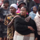 People gather near the crime scene where the body of a woman was discovered in Boksburg on September 17, 2026.