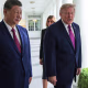 President Trump and President Xi Jinping walking along the White House colonade with their wives behind them.