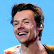 Harry Styles plays guitar on stage