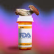 Photo illustration of a pill bottle that reads "FDA approved" and a psychedelic mushroom atop it 