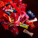 Halloween candy spilled from an orange bag onto a table